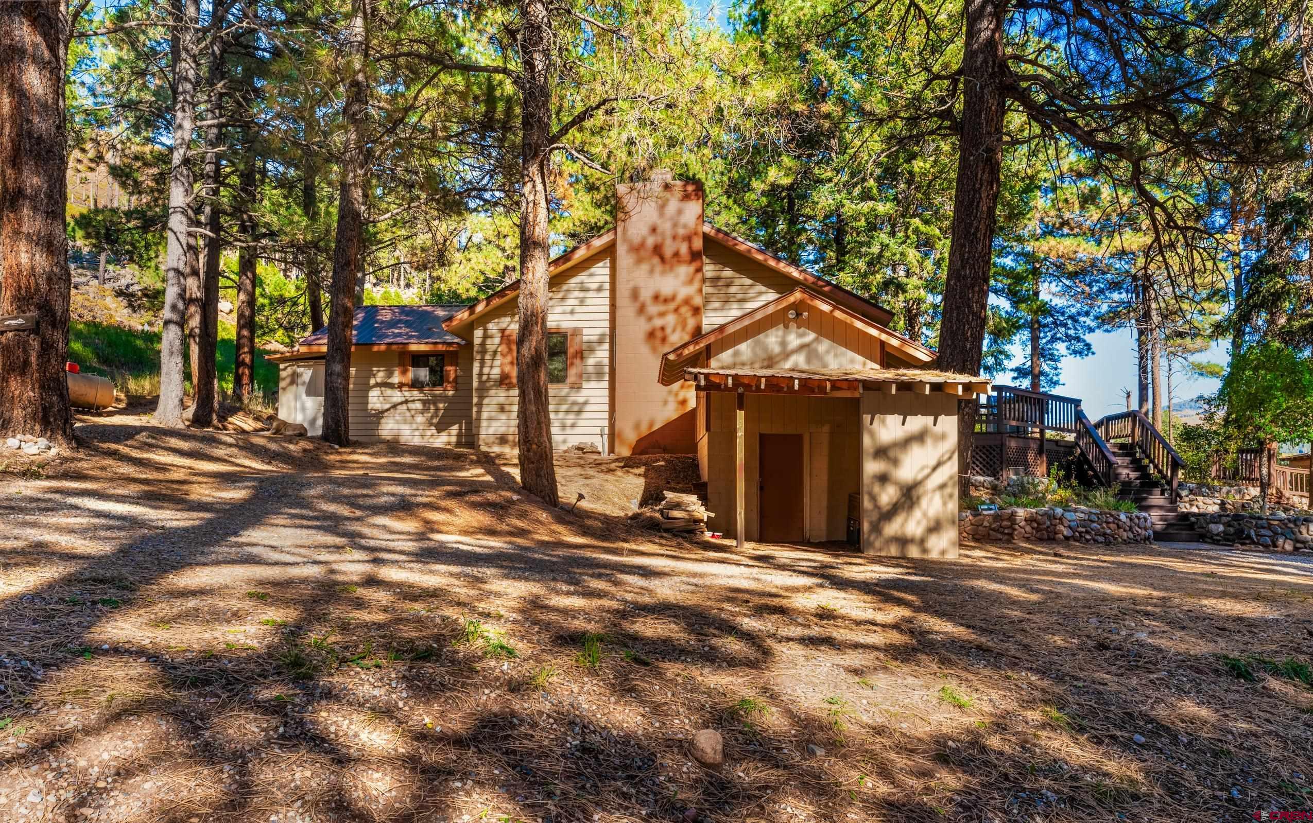 a view of a house with large trees