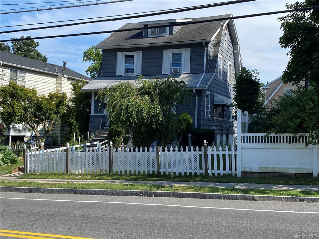 a view of a house with a yard and deck