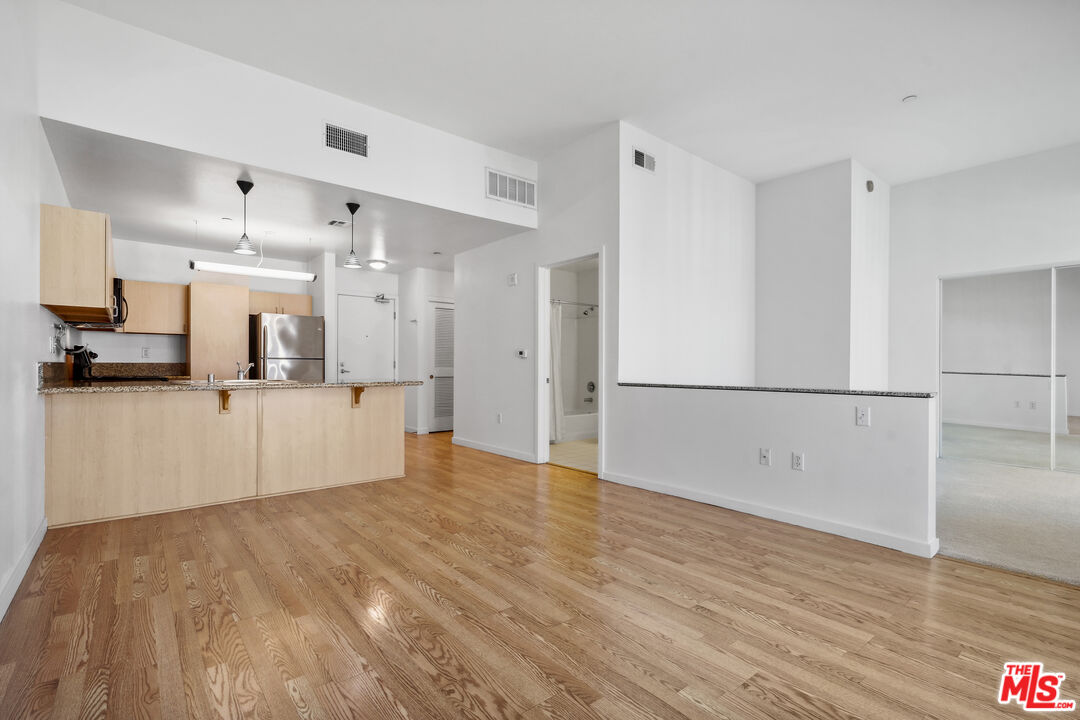 a view of a kitchen with wooden floor