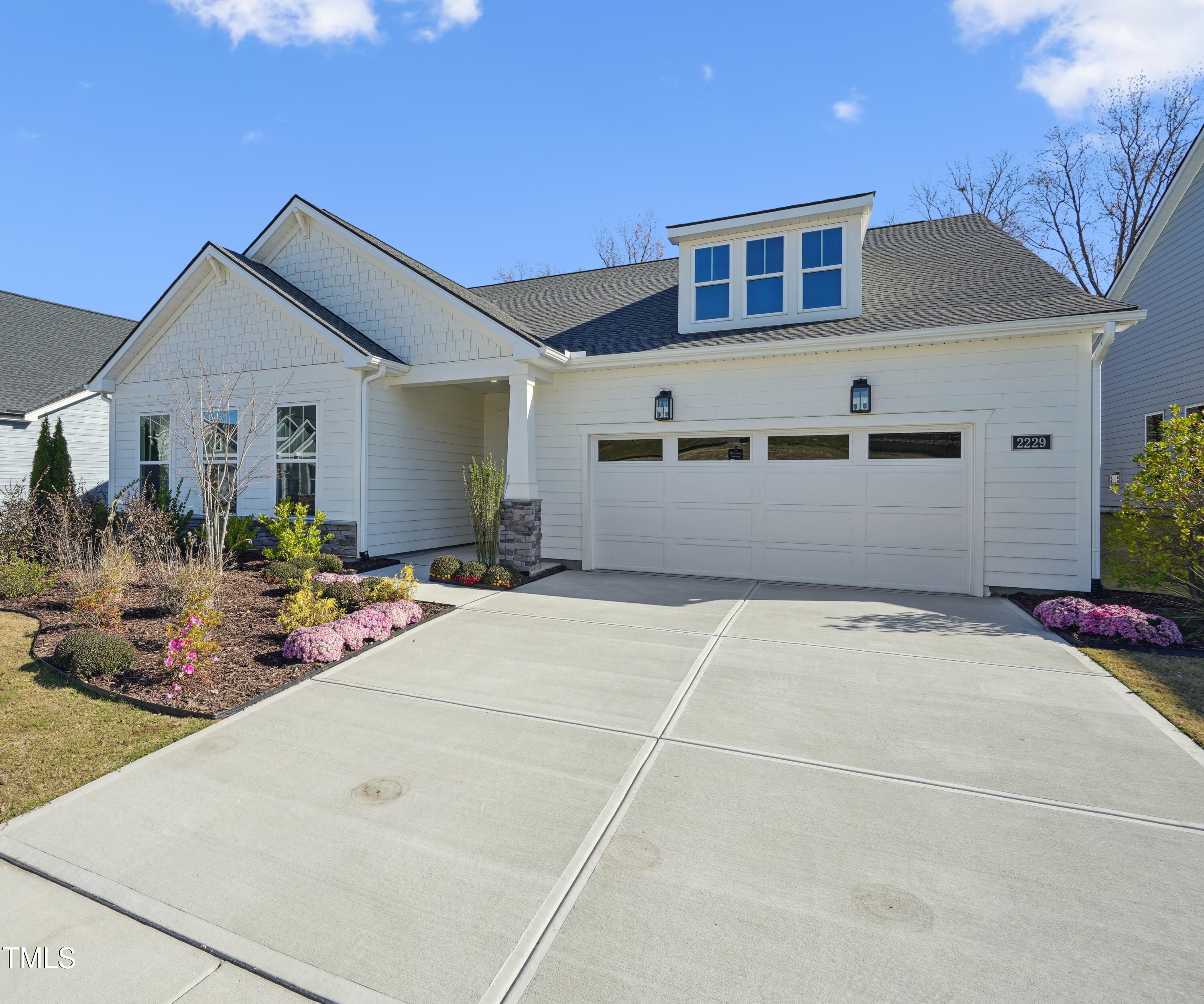 a very nice looking house with a large window and potted plants