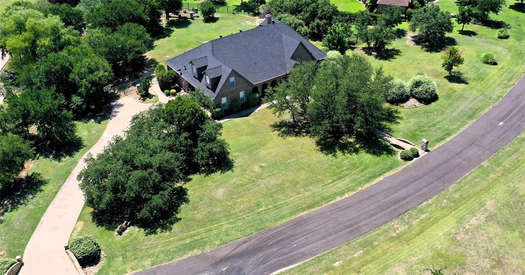 an aerial view of a house with a yard