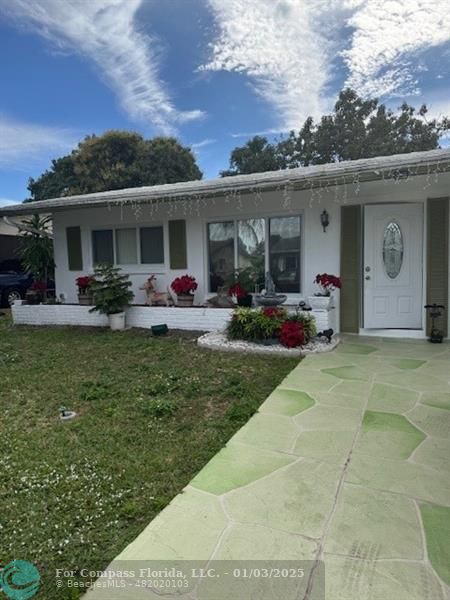 a front view of house with yard and outdoor seating