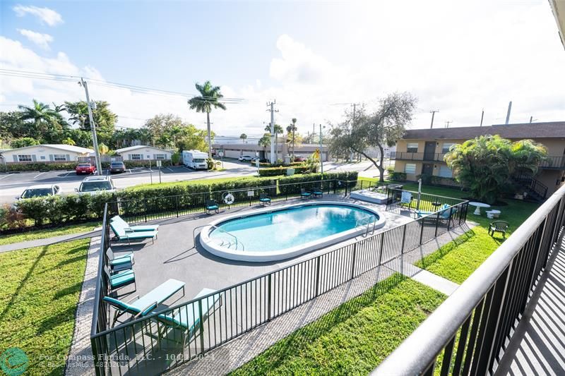 a view of a swimming pool with a patio and a garden