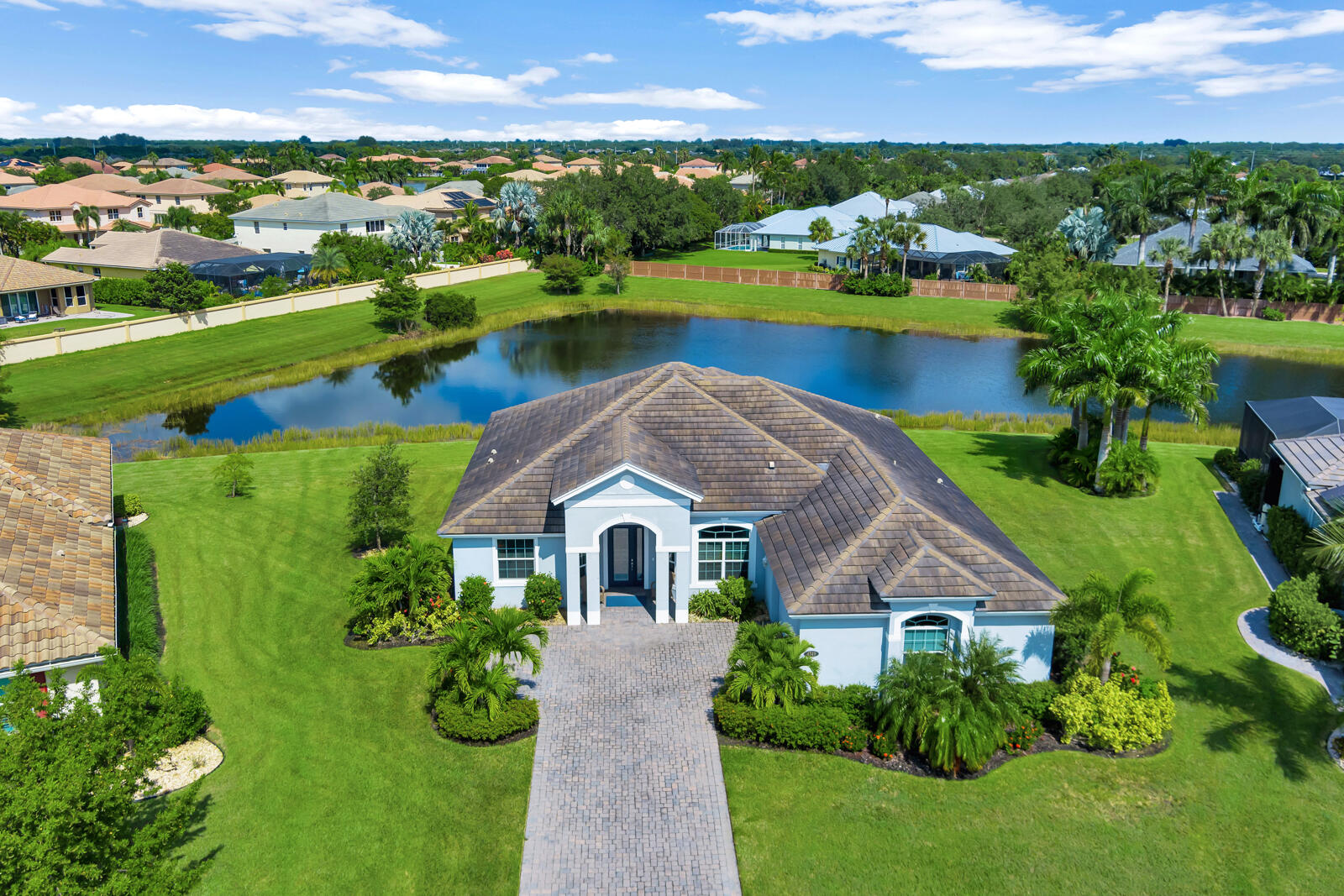 an aerial view of house with yard and green space