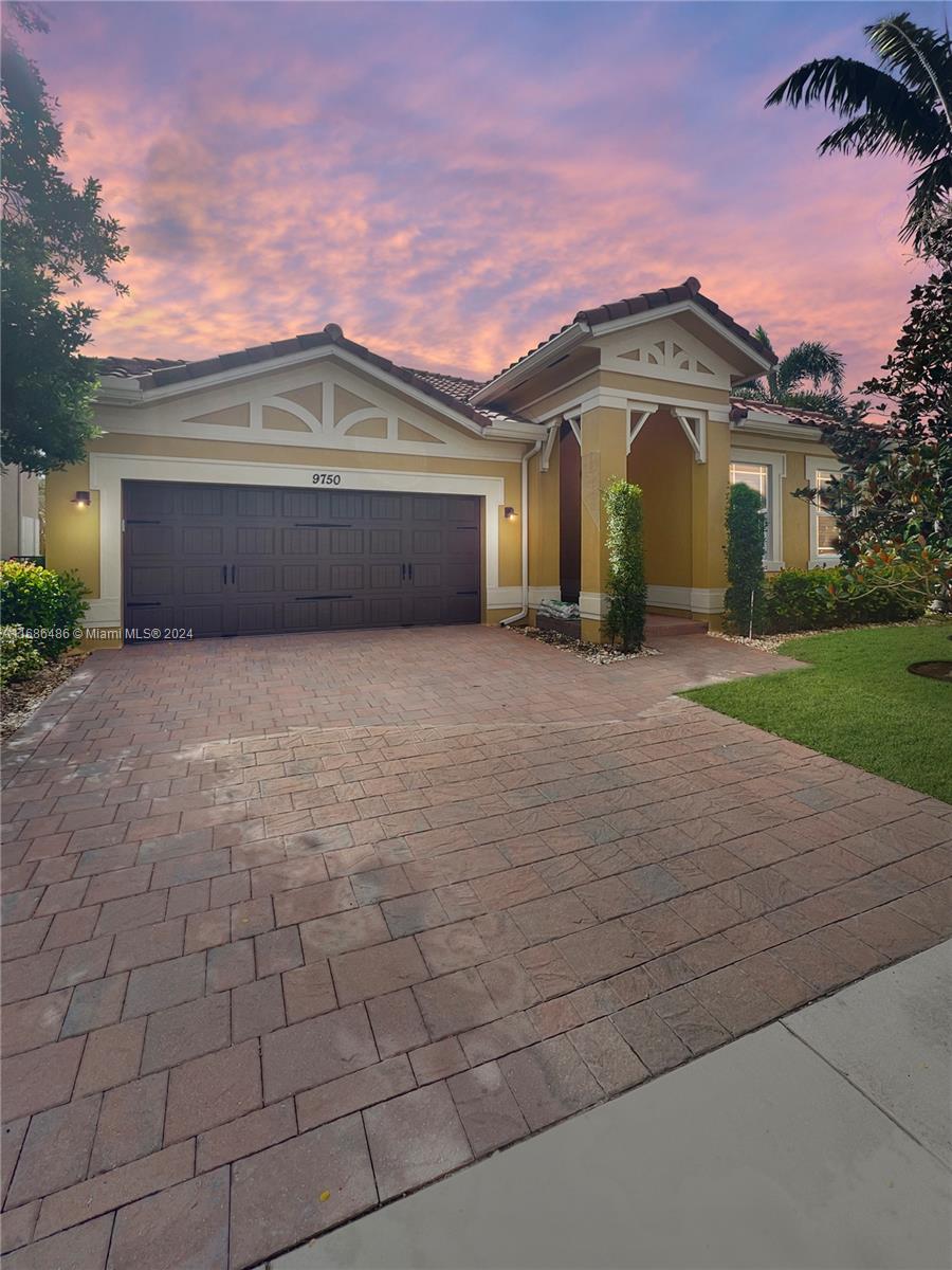 a front view of a house with a yard and garage