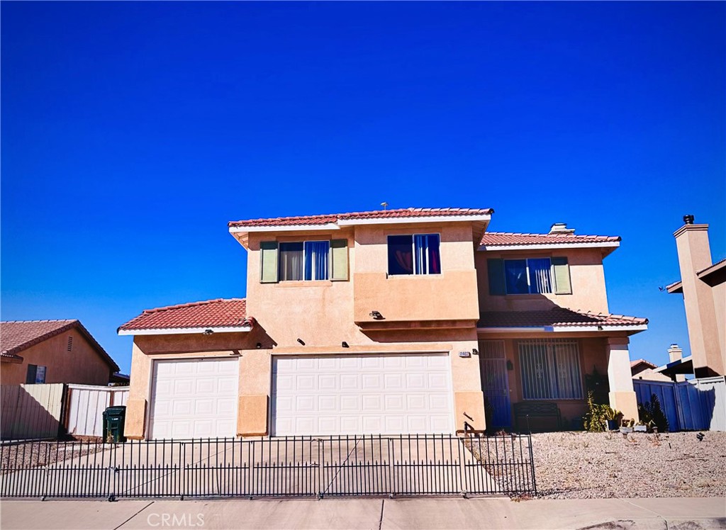 a view of a house with wooden fence