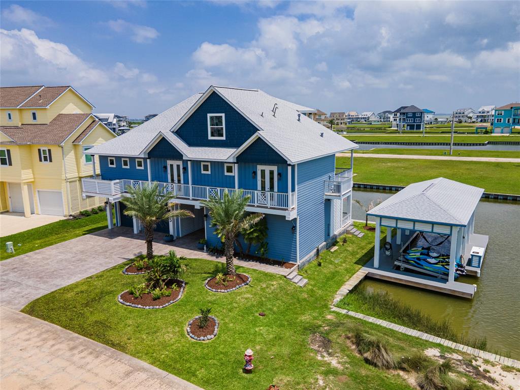 a aerial view of a house with swimming pool and a yard