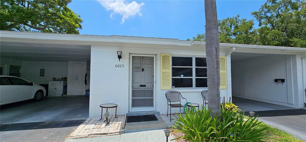 a front view of a house with outdoor seating