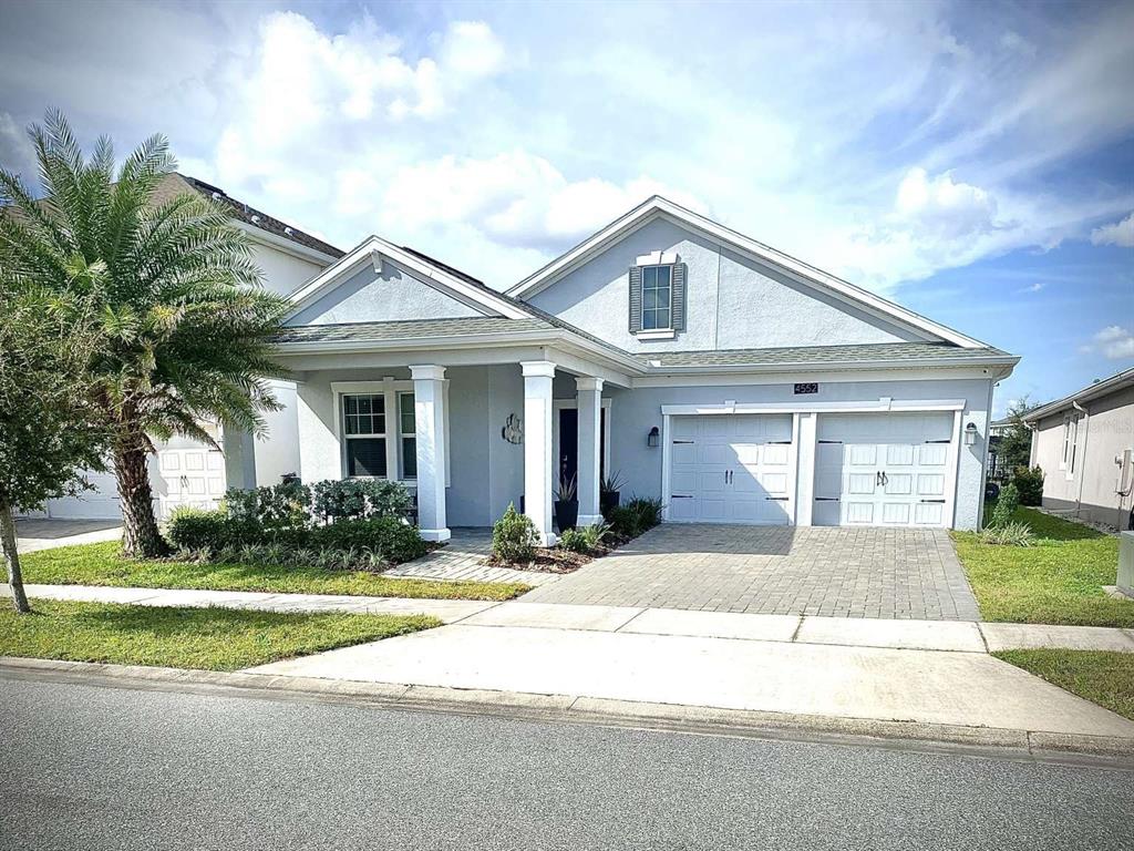 a front view of a house with a yard and garage