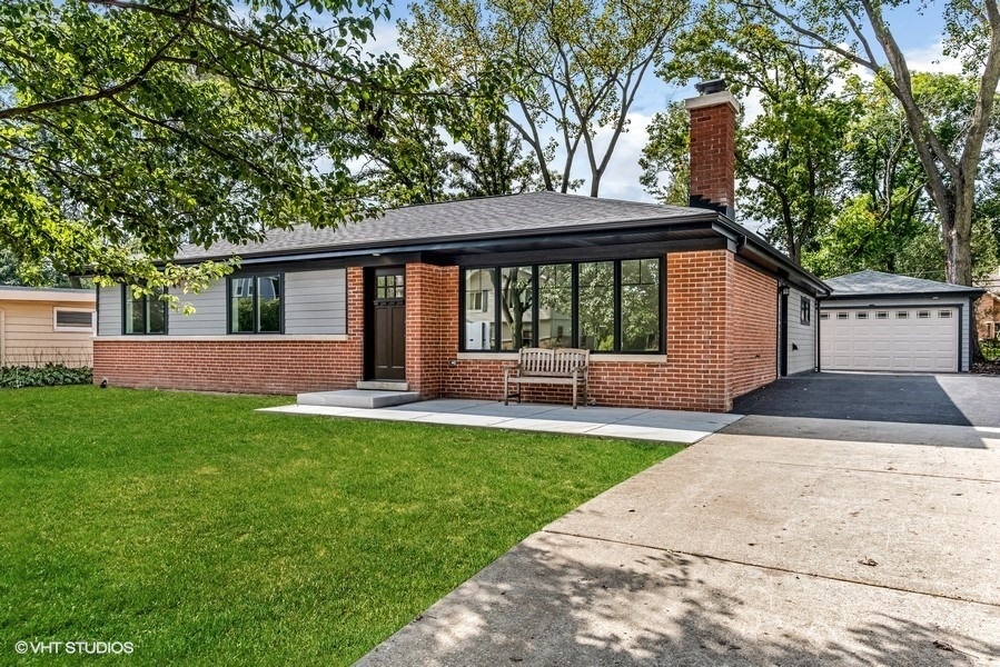 a view of house with backyard and a garden