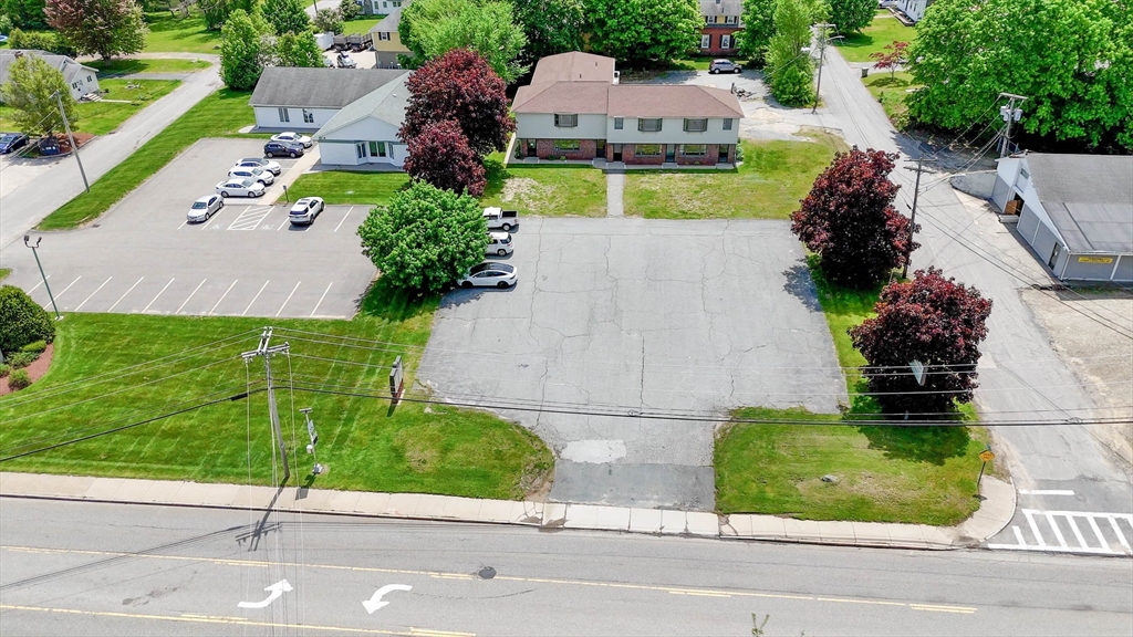 an aerial view of a house with a garden and a yard