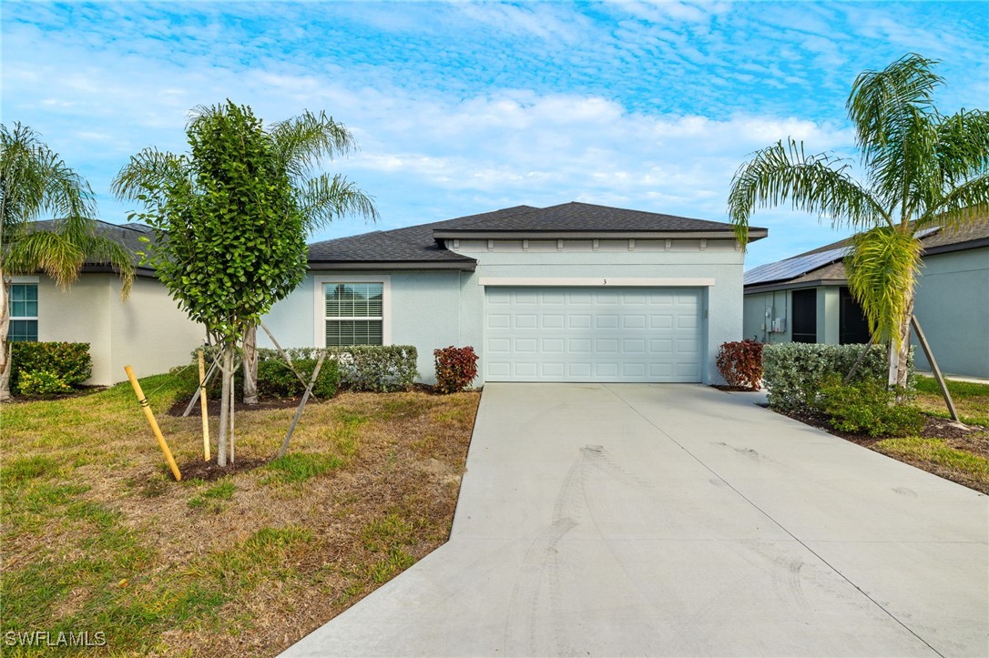 a view of a house with a yard and palm trees