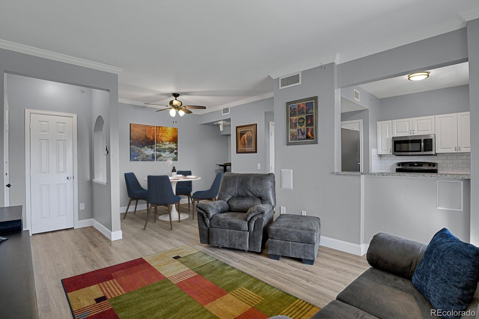 a living room with furniture and a wooden floor