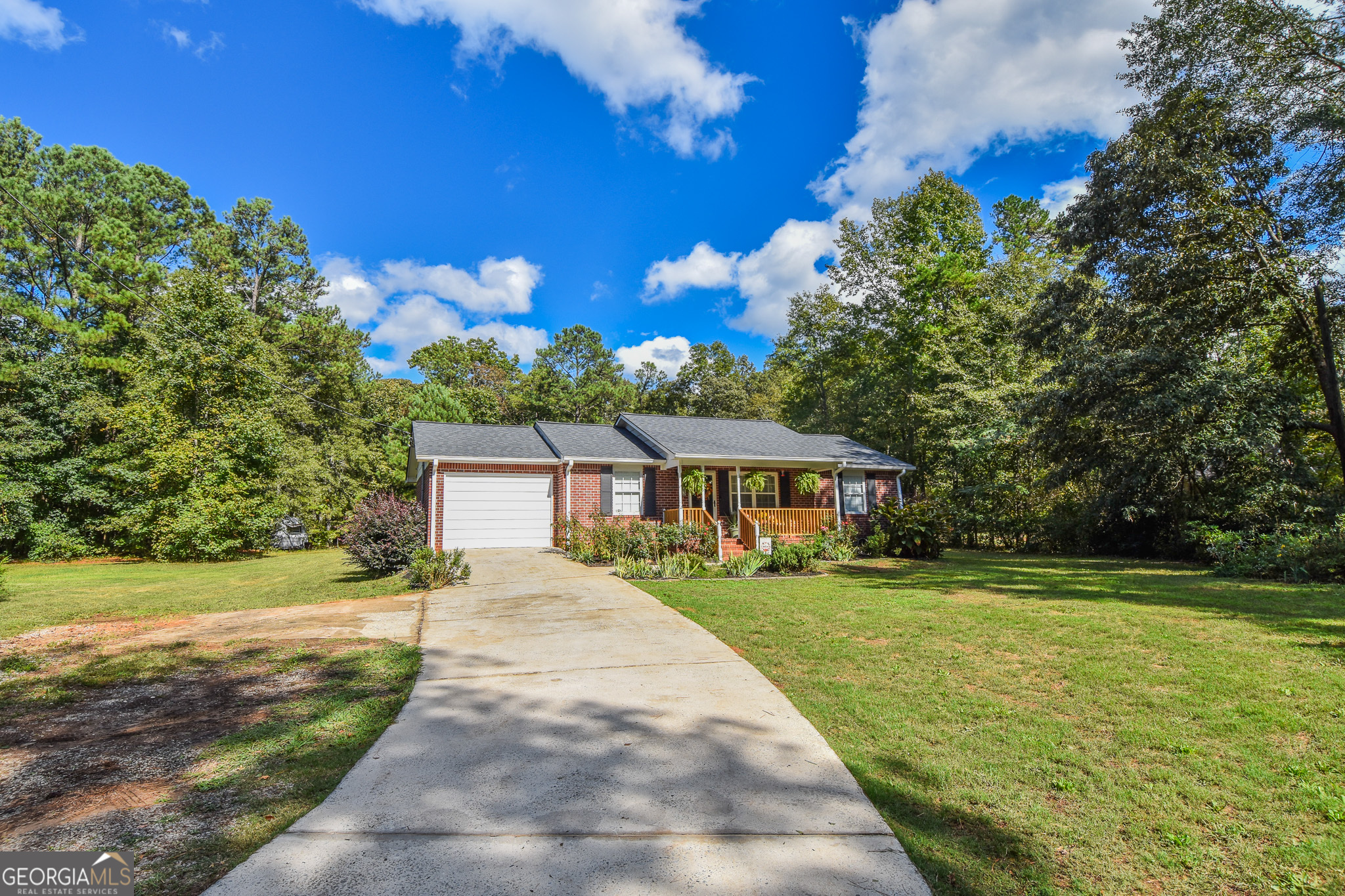 a front view of a house with a yard and trees