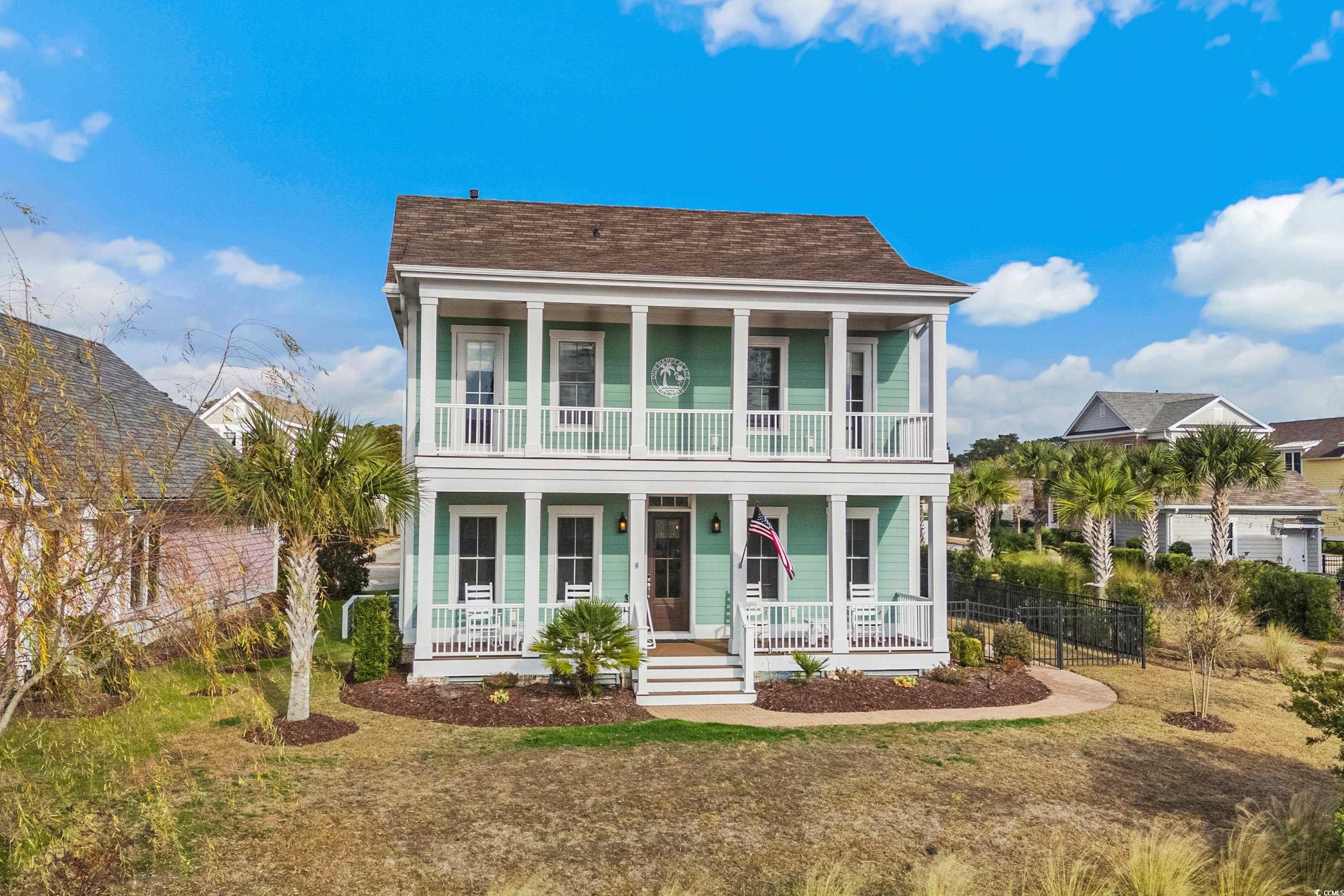 View of front of home with a porch, a balcony, and