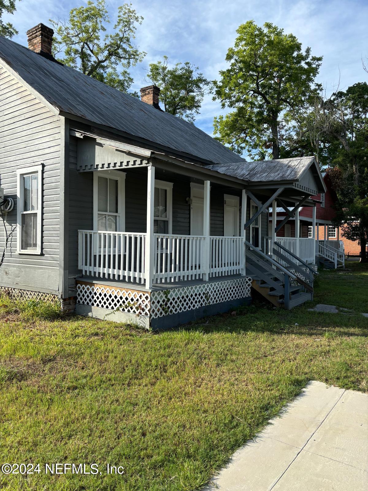 a view of a house with a yard and deck