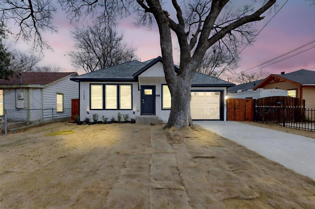 a view of a house with a yard and garage