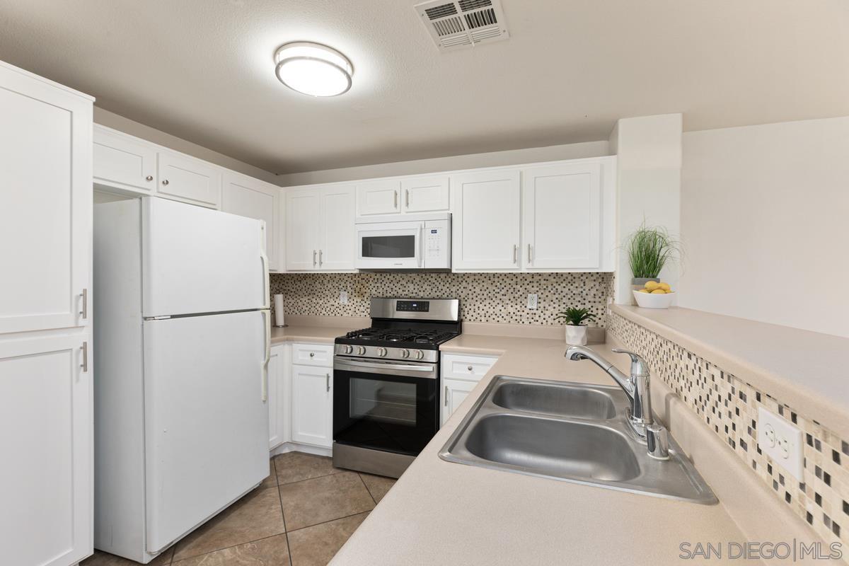 a kitchen with a refrigerator sink and stove