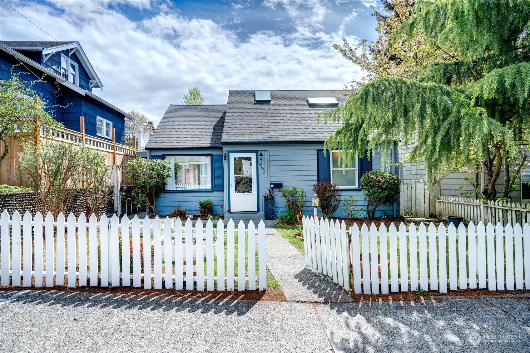 a front view of a house with a garden