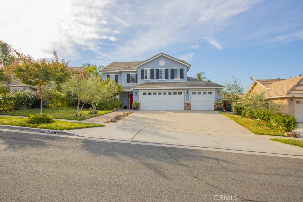 a view of house with yard and entertaining space