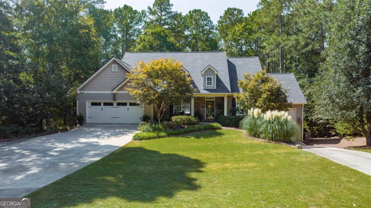 a view of a house with a yard and tree s