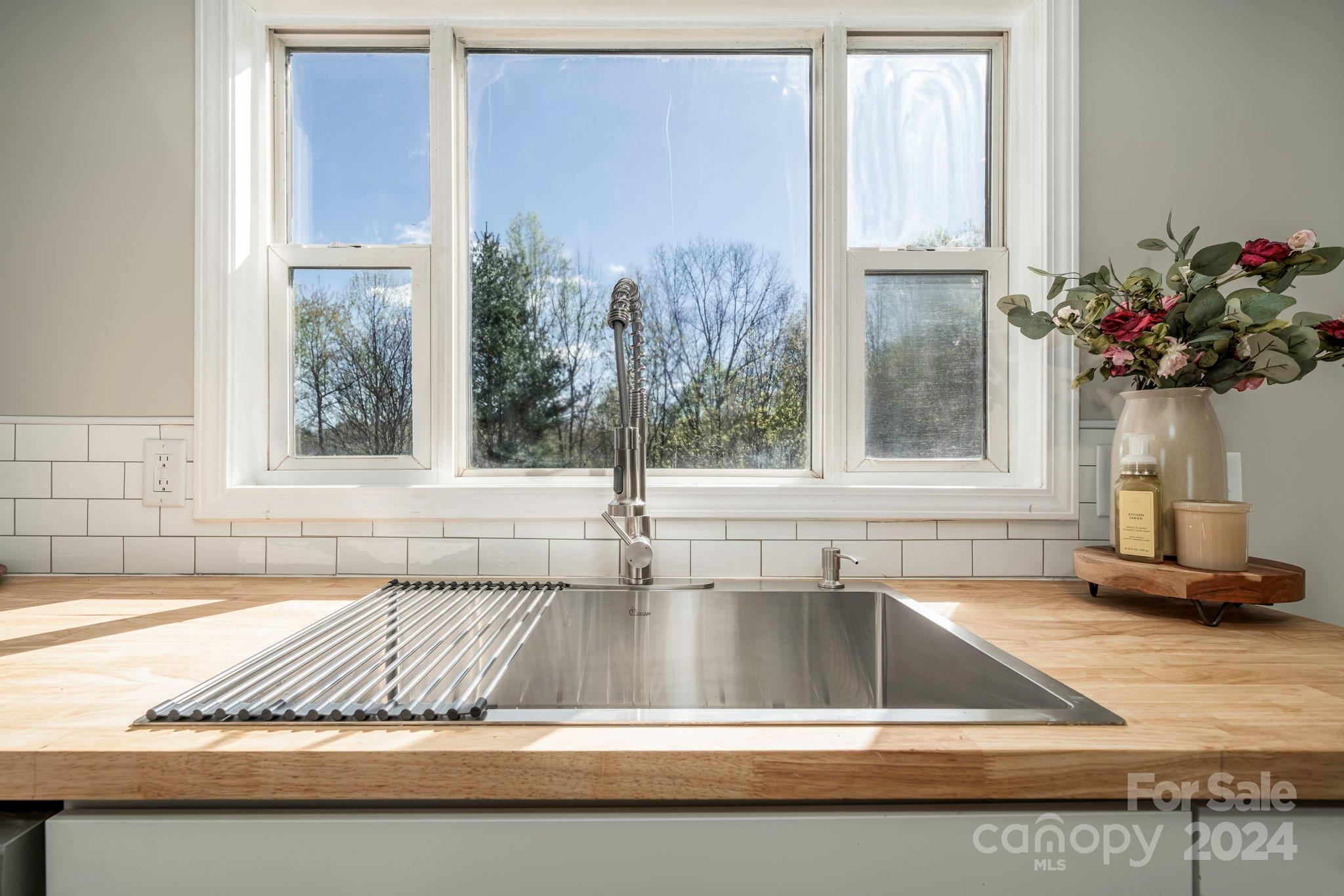 a view of a kitchen counter top a sink and dishwasher