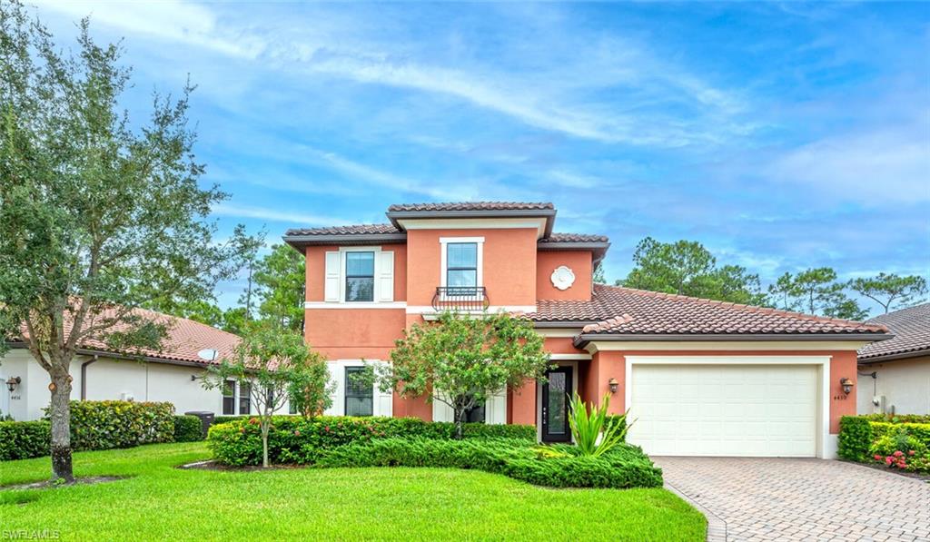 Mediterranean / spanish-style house featuring a front yard and a garage