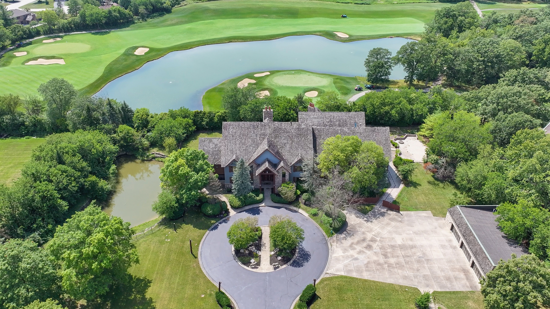 an aerial view of a house a yard and a swimming pool