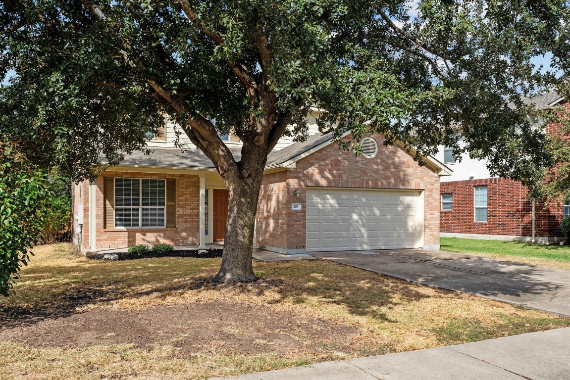 a front view of a house with a yard and garage