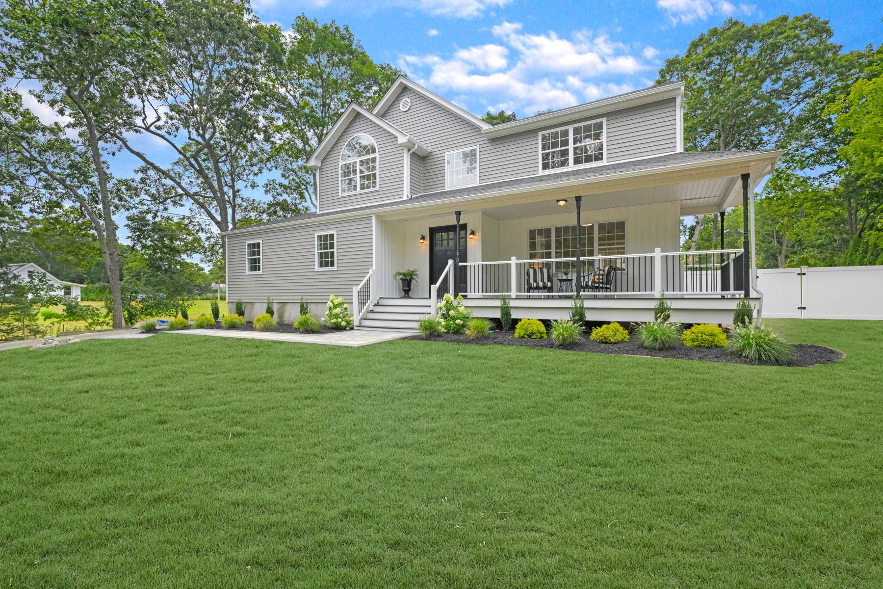 a front view of house with yard and outdoor seating