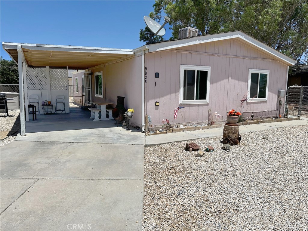 a front view of a house with outdoor seating