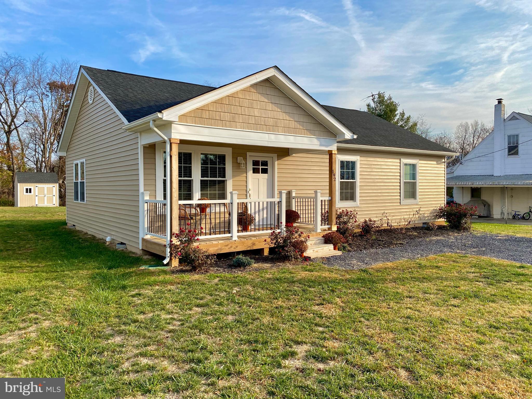 a view of a house with backyard sitting area and garden