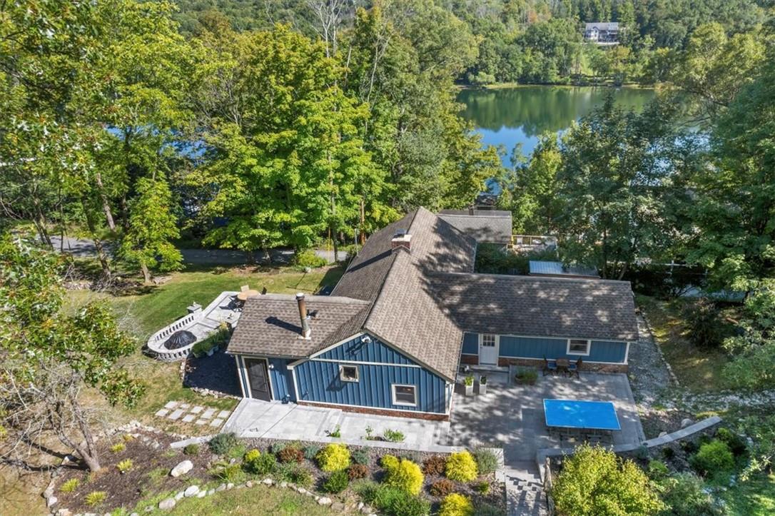 Birds eye view of property with a water view