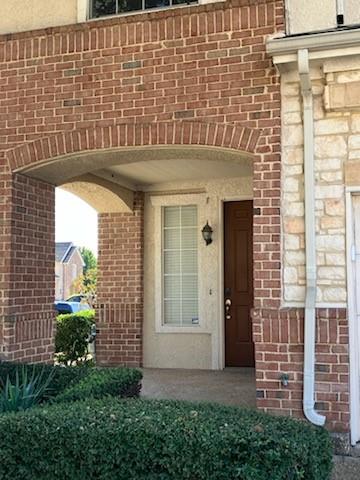 a view of a brick house with a large window