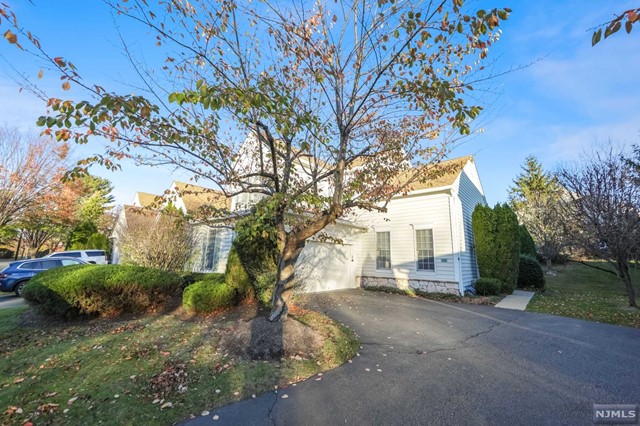 a view of a house with a tree