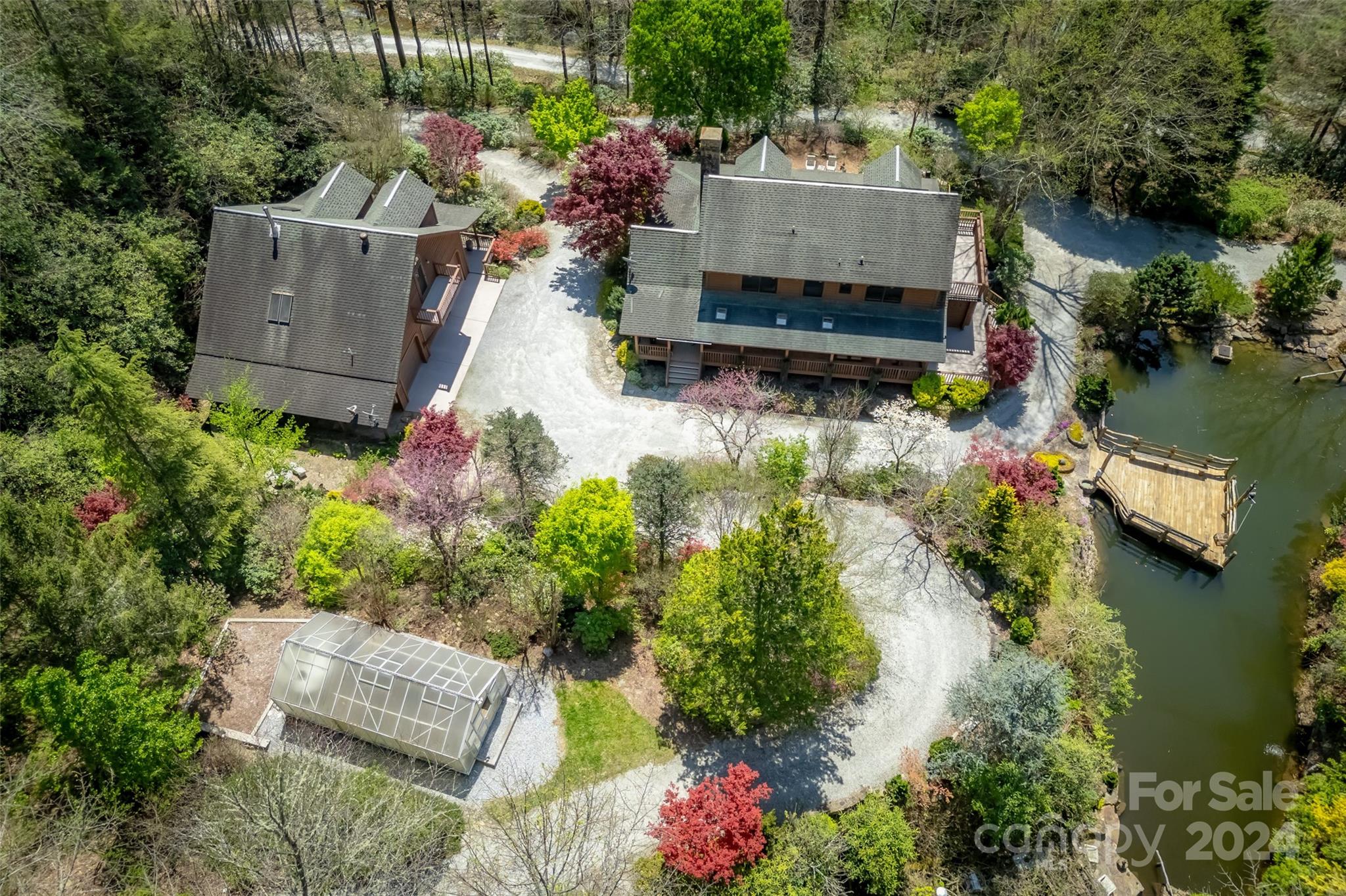 an aerial view of a house with a yard and lake view