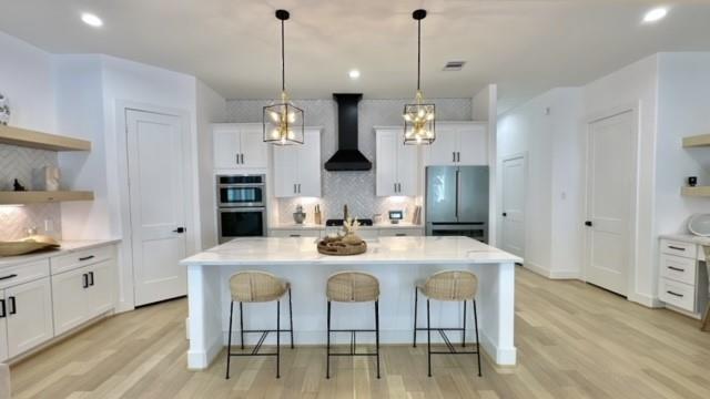 a kitchen with a dining table chairs and white cabinets