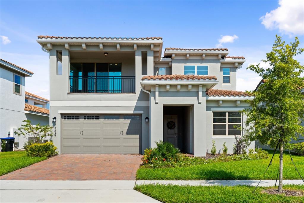 a front view of a house with a yard and garage