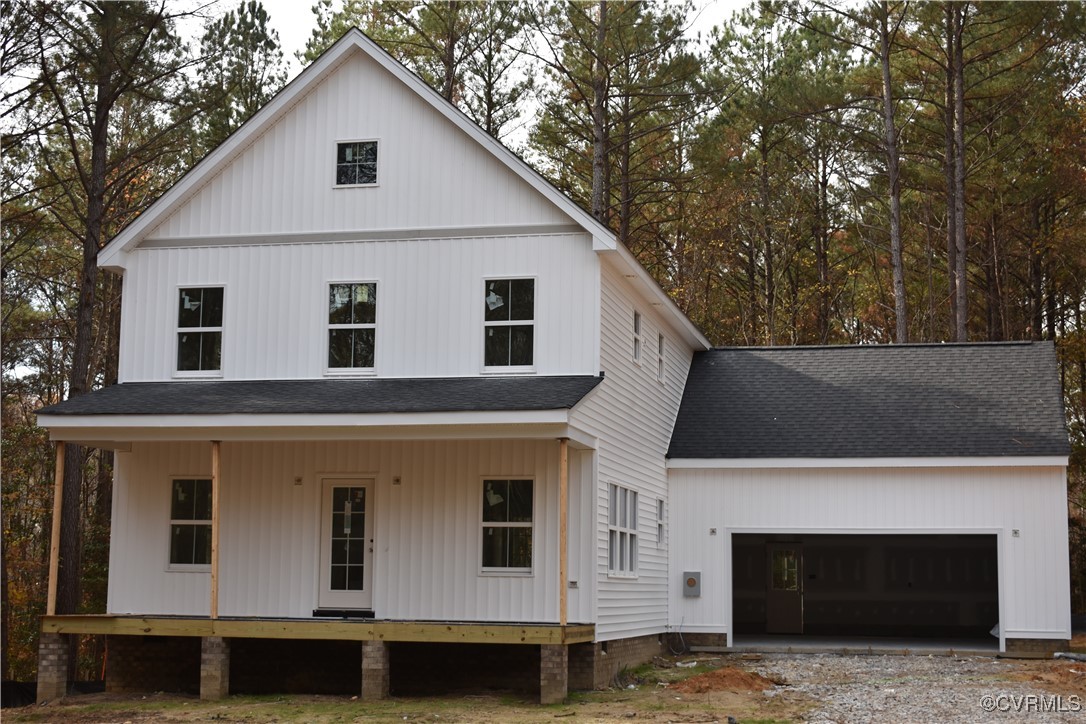 Modern farmhouse style home with a porch and a gar