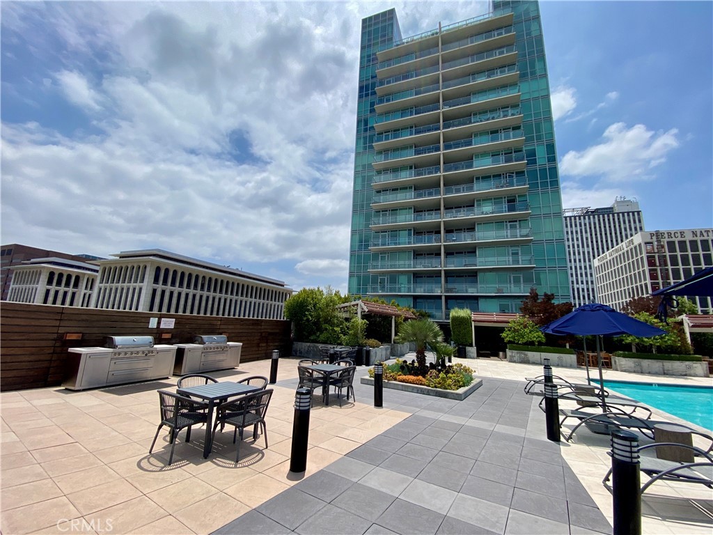 a view of balcony with outdoor seating and barbeque oven