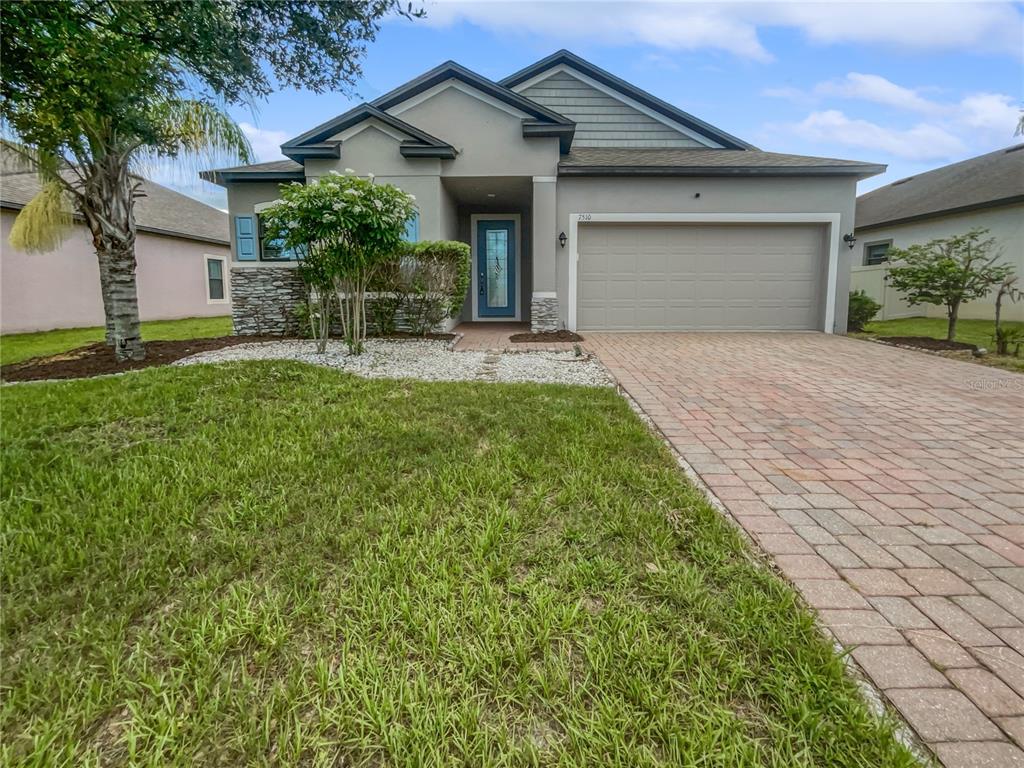 a front view of a house with a yard and garage