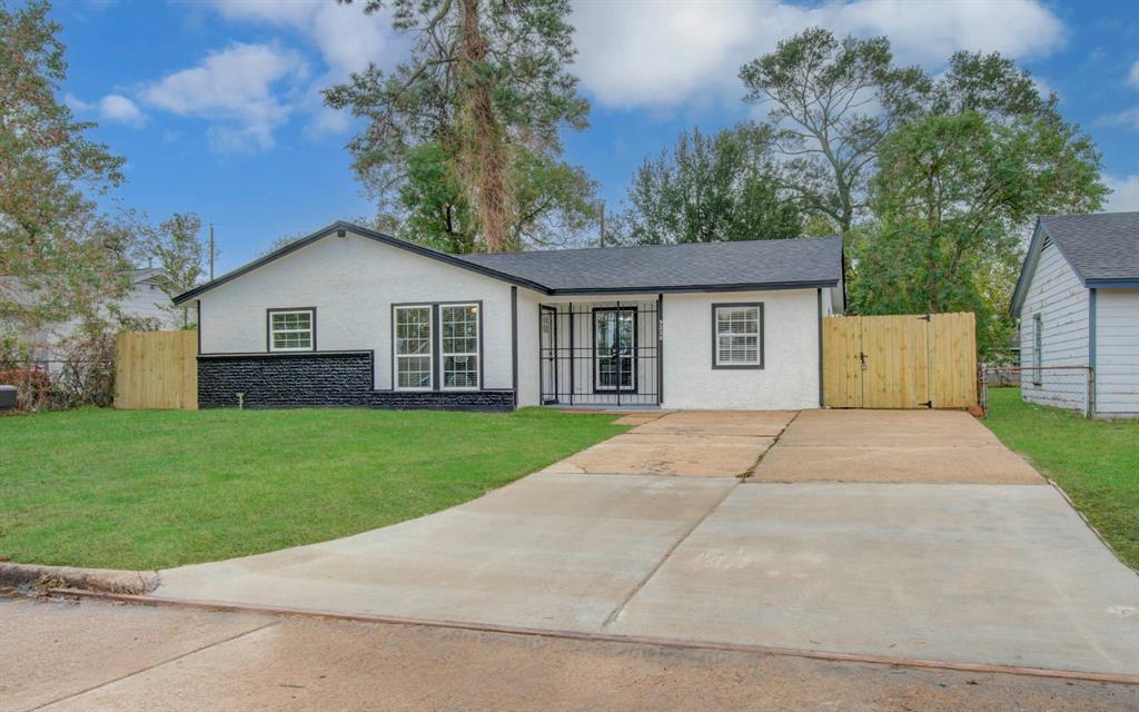 front view of a house with a yard and a garage