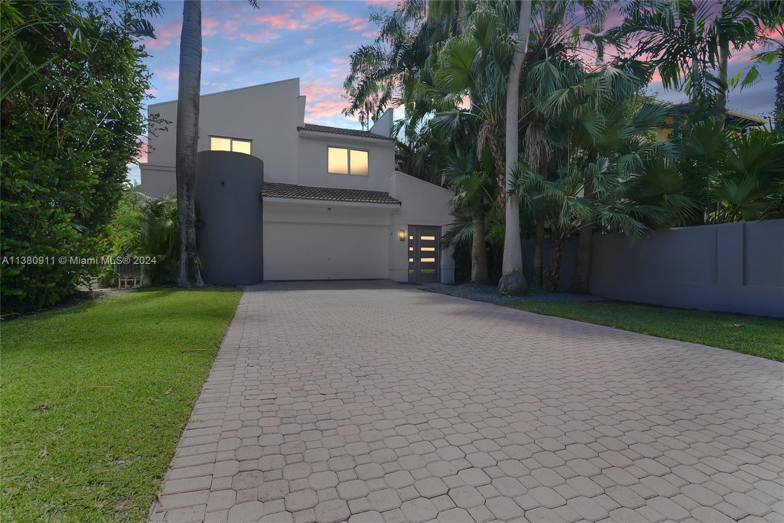 a view of a house with a yard and a garage