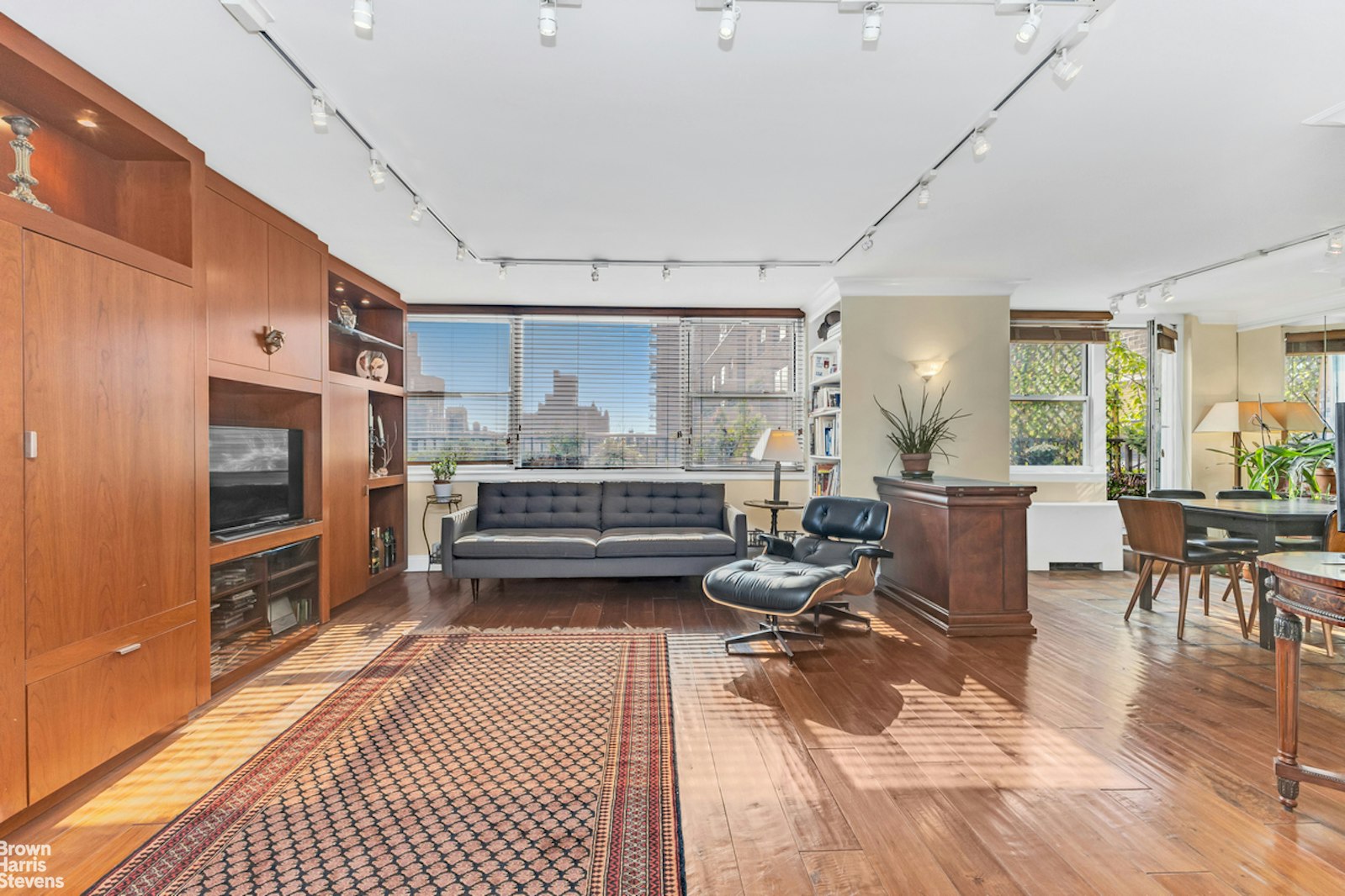 a living room with stainless steel appliances kitchen island granite countertop furniture and a kitchen view