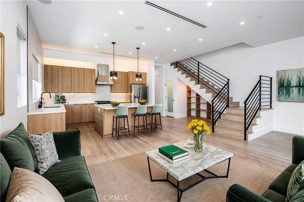 a living room with furniture and kitchen view