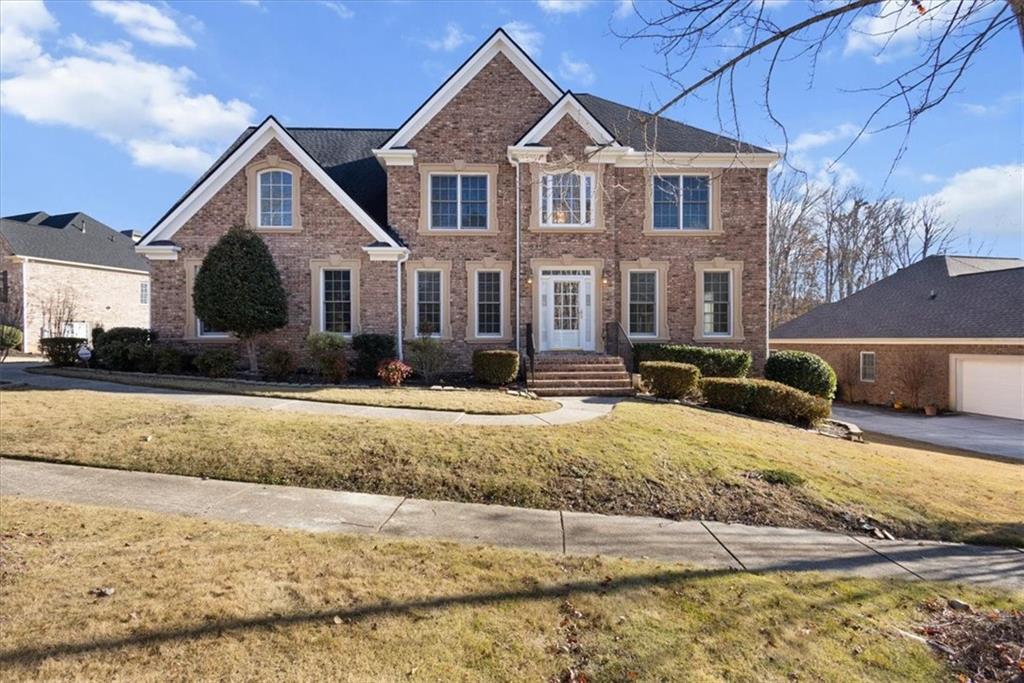 a front view of a house with a yard