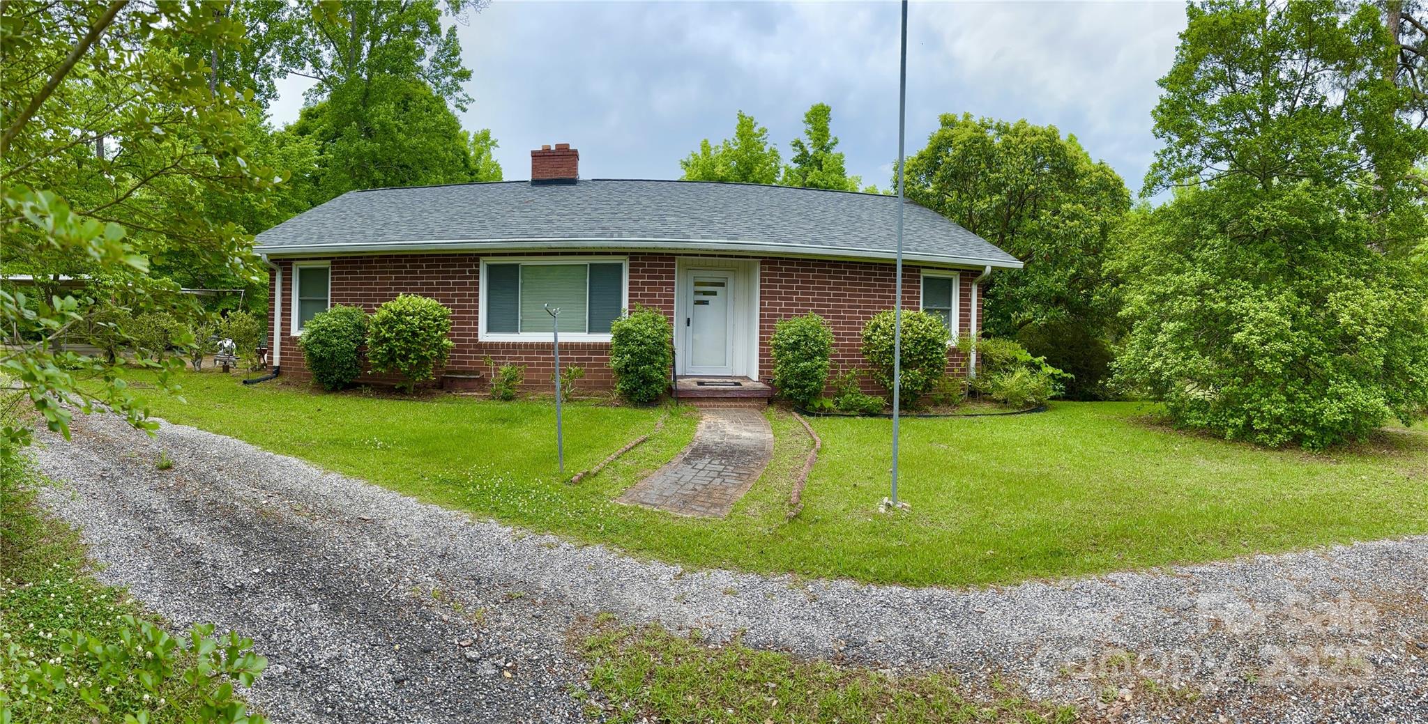 a view of a house with a yard and plants