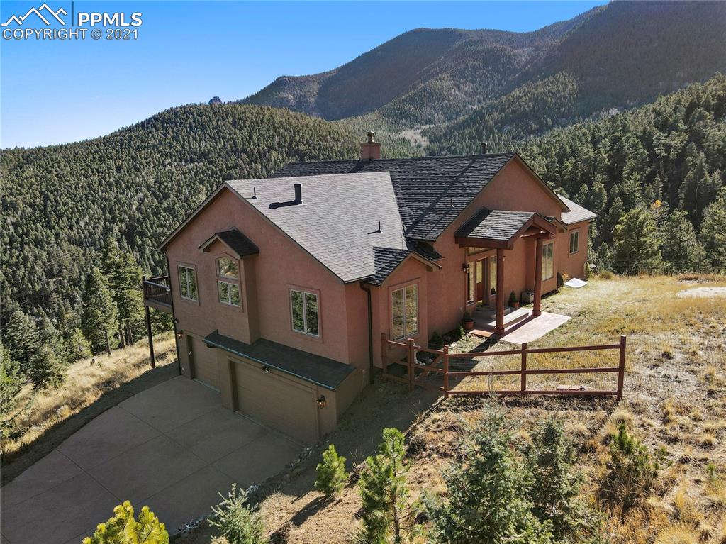 an aerial view of a house with a yard