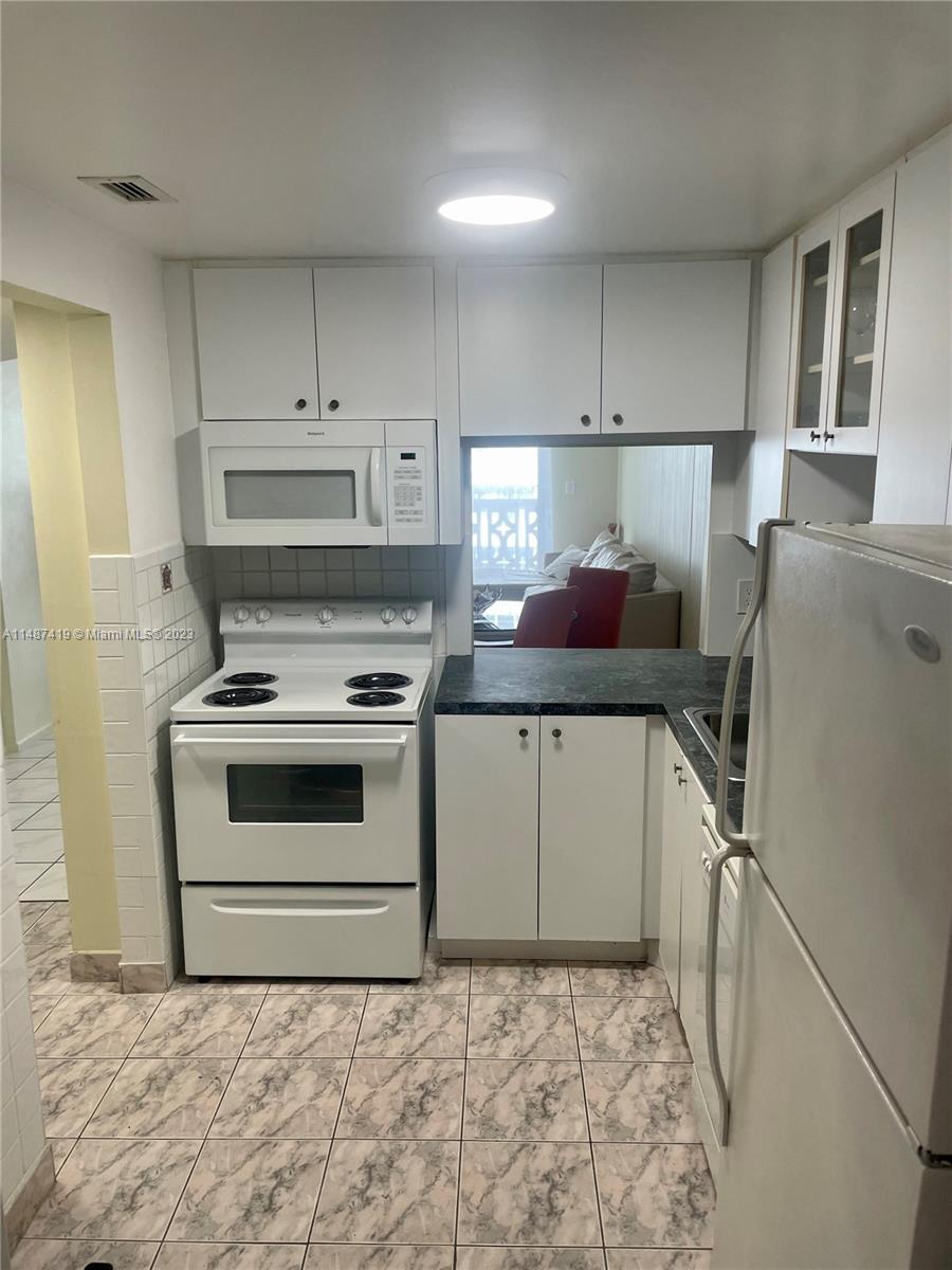 a kitchen with a stove and a refrigerator