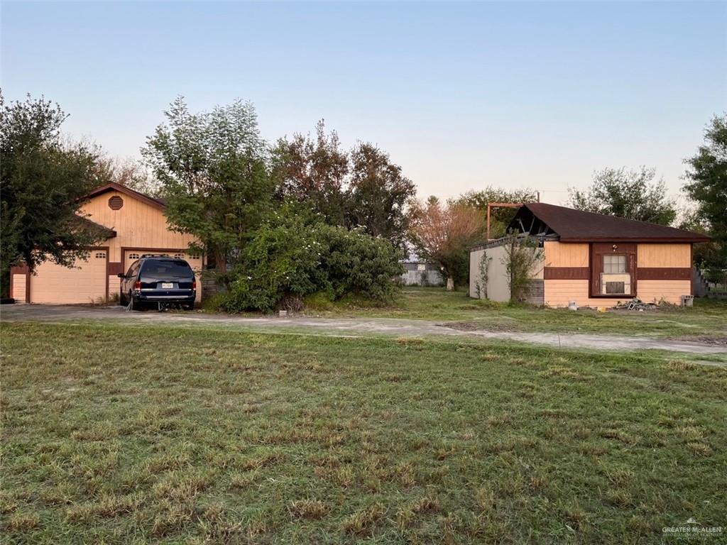 a car parked in front of a house with a yard